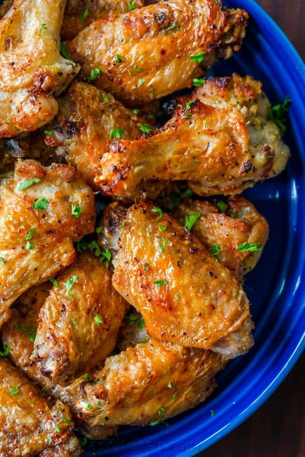 Air Fryer chicken wings garnished with parsley in blue bowl