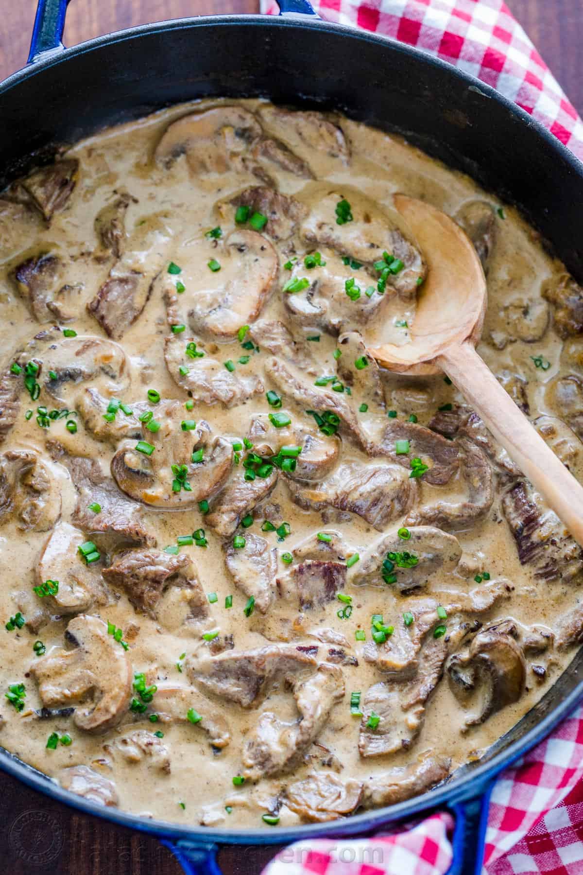 Beef Stroganoff in a pan garnished with chives