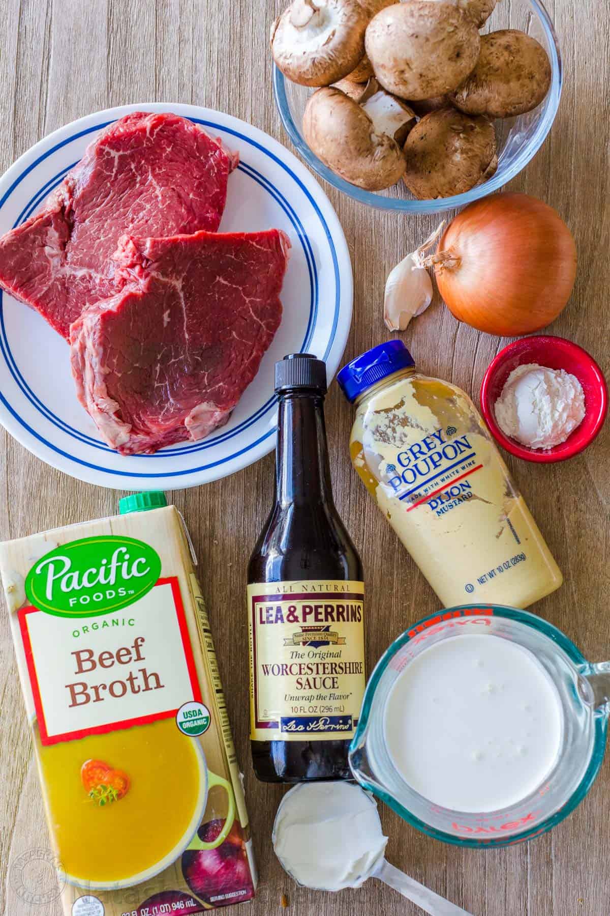 Ingredients for stroganoff with beef, mushrooms, broth, mustard, sour cream, whiping cream