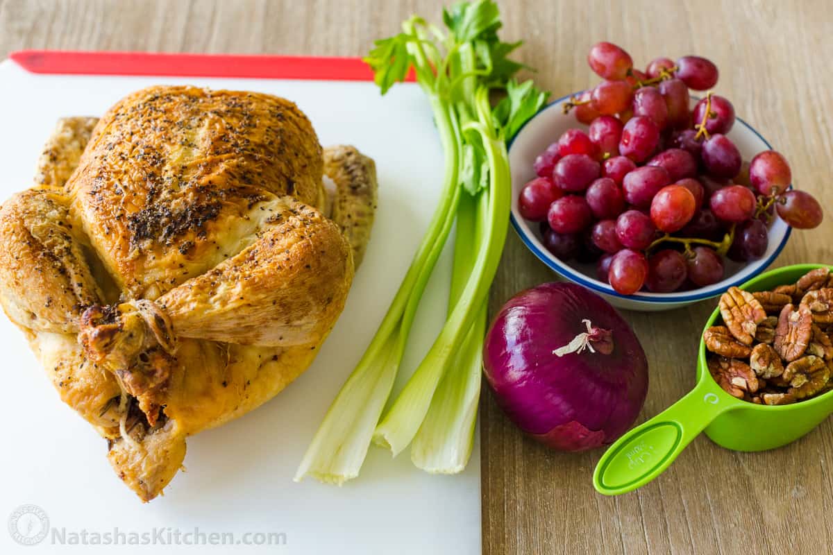 Ingredients for making chicken salad with roasted chicken, celery, grapes, pecans and onion