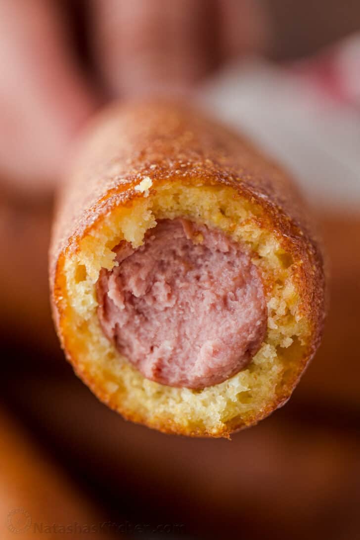 bitten corn dog showing sausage and corn bread center