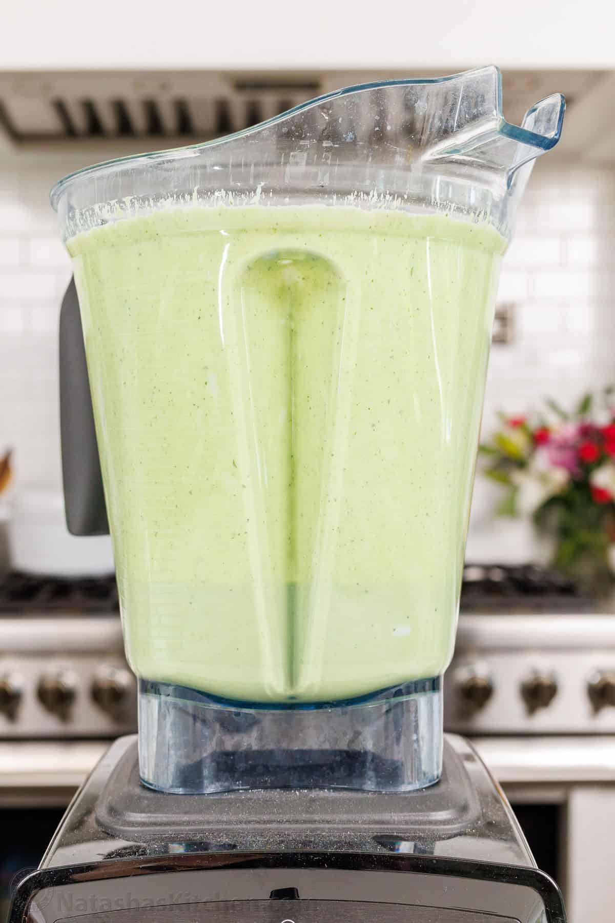 Green Goddess dressing mixed in a blender in a white kitchen