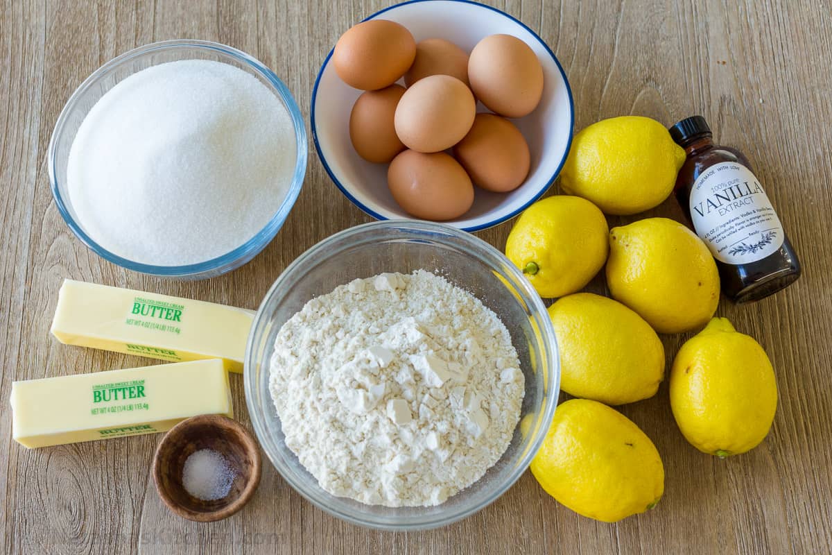 Ingredients for making lemon bars with lemons, eggs, flour, butter, sugar, vanilla and salt