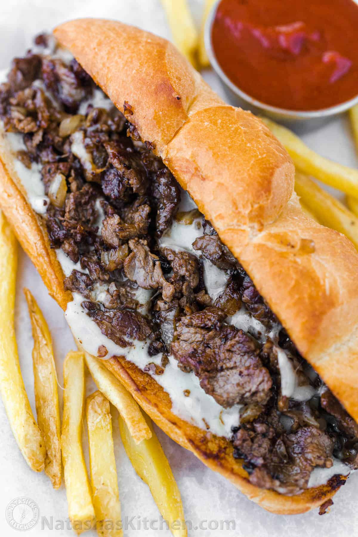 How to serve Philly cheesesteak sandwiches on a hoagie roll with fries
