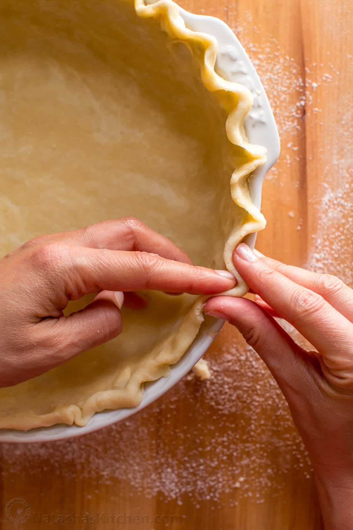 This homemade Pie Crust recipe yields a flaky, tender crust with rich buttery flavor. An easy pie dough - perfect for sweet or savory pies. Pie Crust in a white pie dish