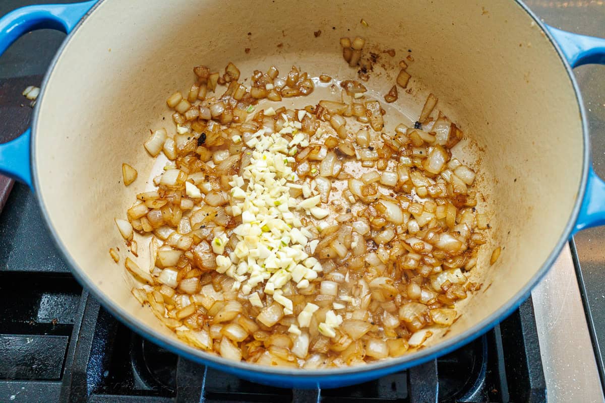 Onions and garlic sauteed in a large dutch oven