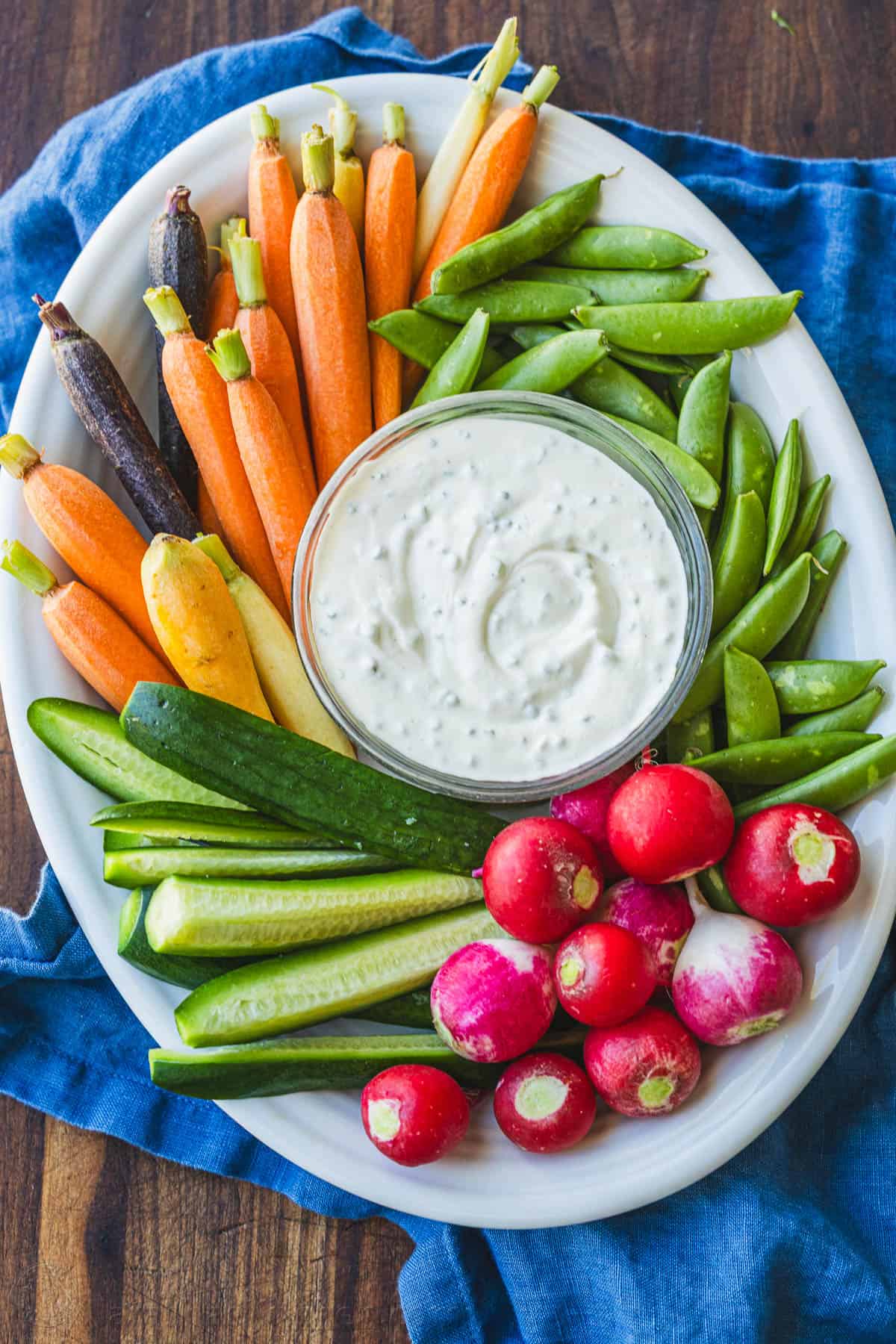 Vegetable platter with Ranch dip on a blue towel