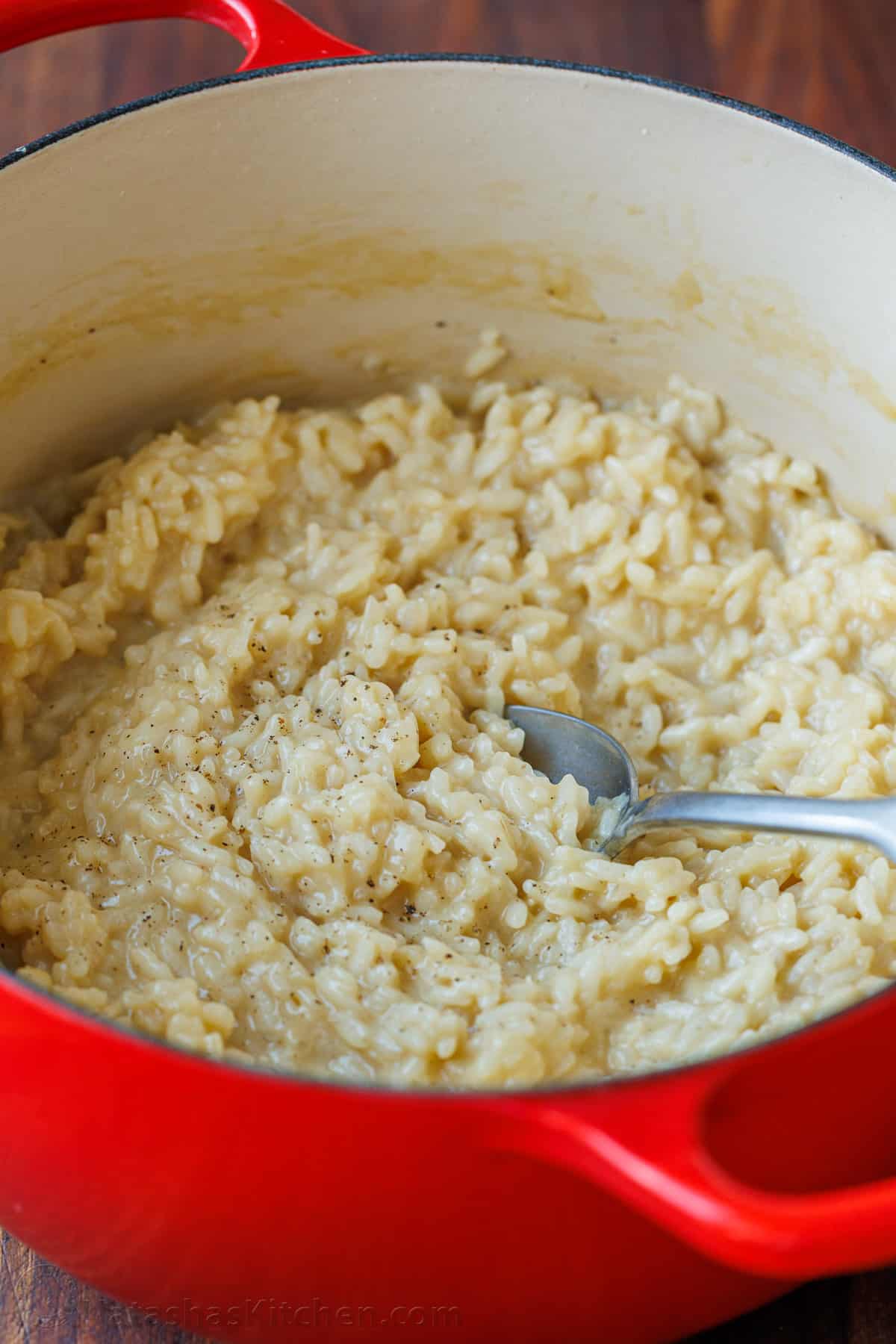 Cooked risotto in a red dutch oven pot 