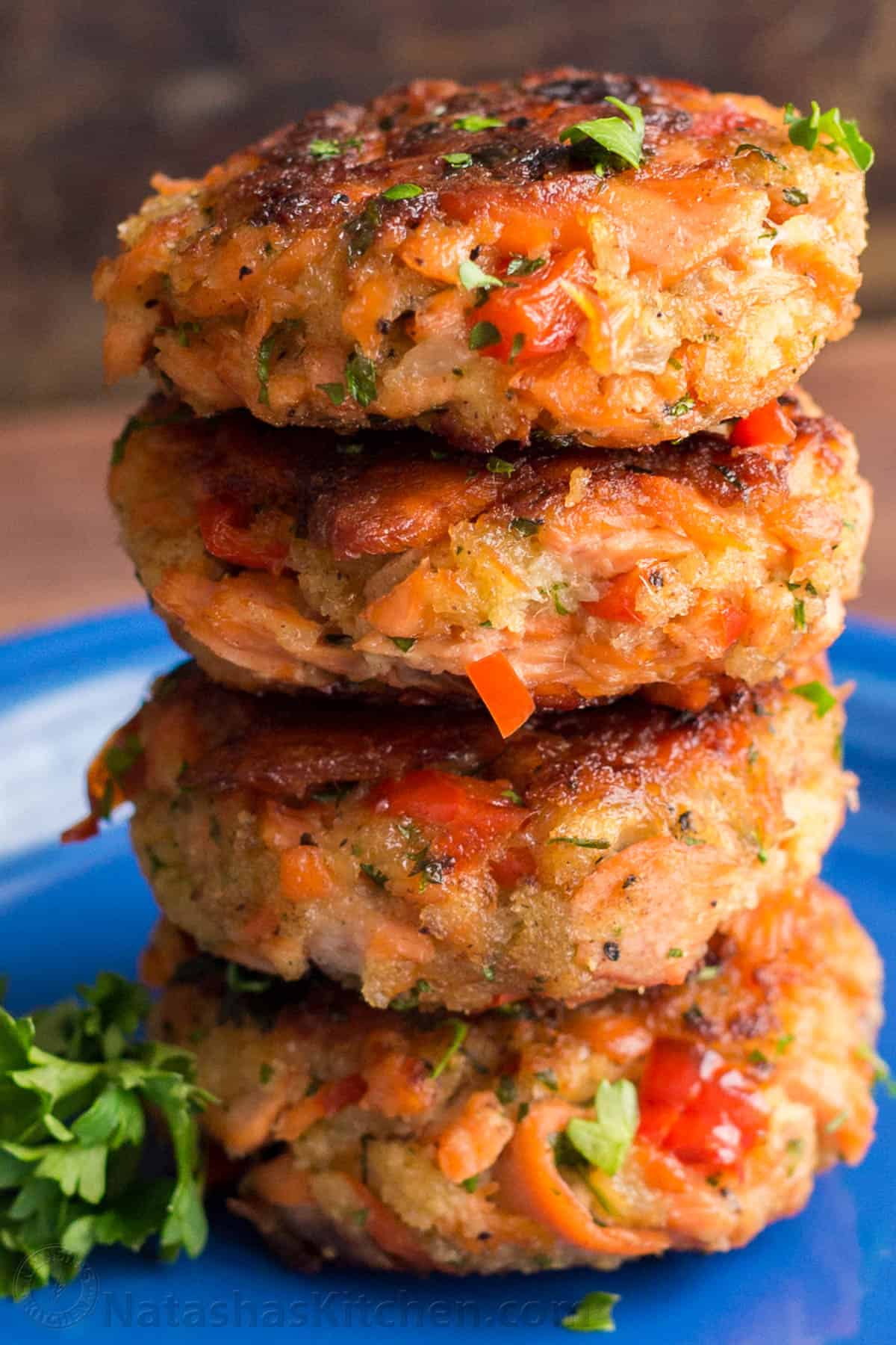 Salmon patties recipe stacked on top of each other on a blue plate