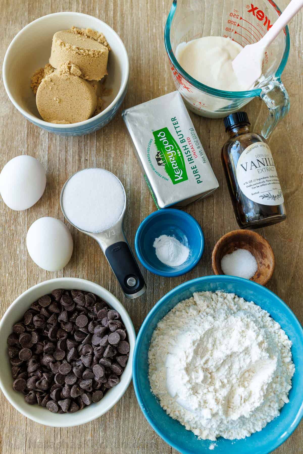 Ingredients for the best discard recipes including brown sugar, discard, butter, vanilla extract, eggs, sugar, salt, baking soda, baking powder, flour and candy