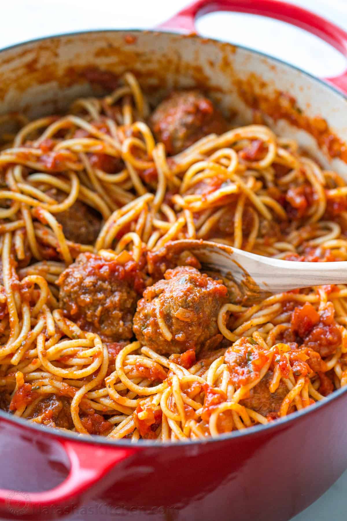 Spaghetti and Meatballs in red pot with serving spoon