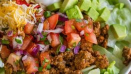 Taco Salad served with toppings in a white bowl