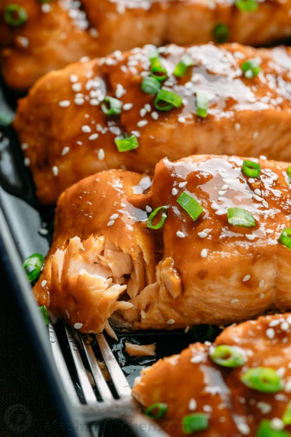Flaked teriyaki salmon to test for doneness when checking how long to bake salmon 