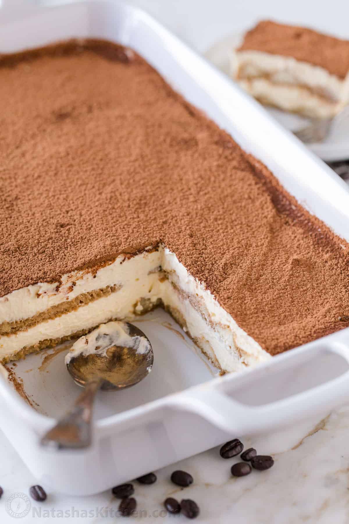homemade tiramisu recipe in a white dish with mascarpone cream layers and ladyfingers soaked in coffee
