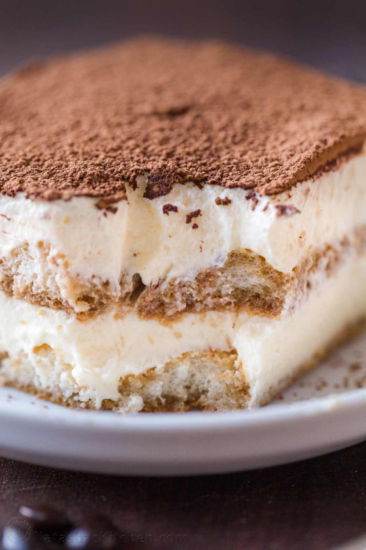 homemade tiramisu recipe in a white dish with mascarpone cream layers and ladyfingers soaked in coffee