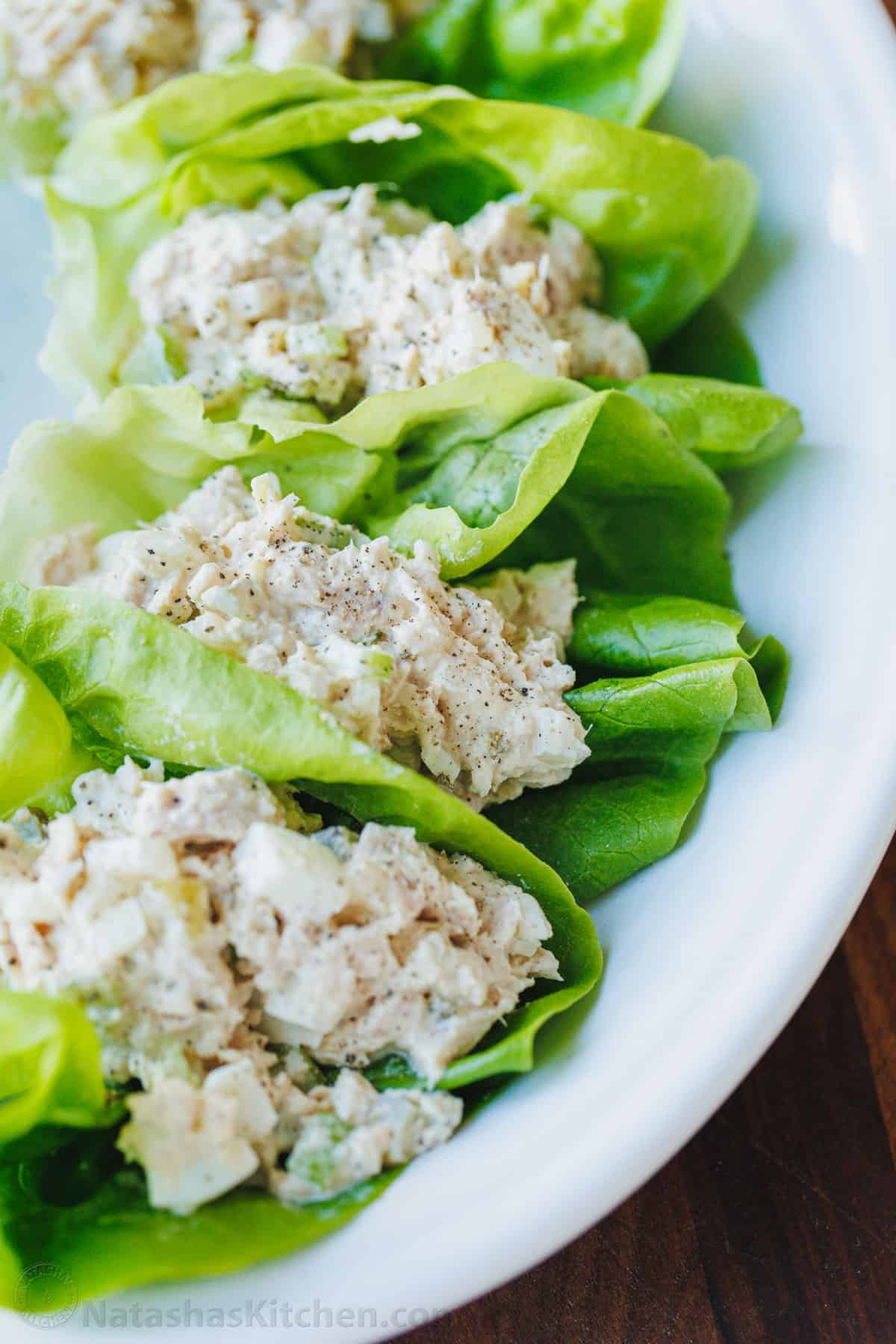 Tuna Salad served over lettuce cups on a white plate with pepper on top
